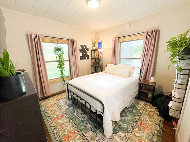 a bed sitting in a bedroom next to a window