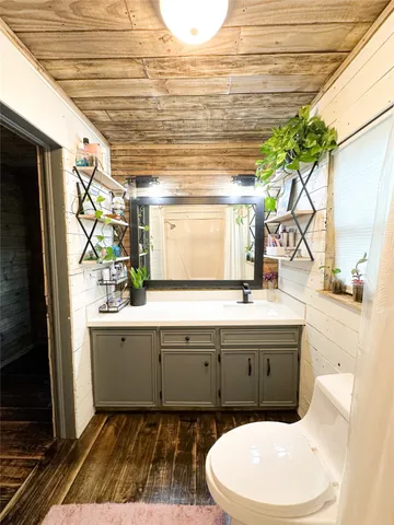 a bathroom with a sink a mirror and a shower