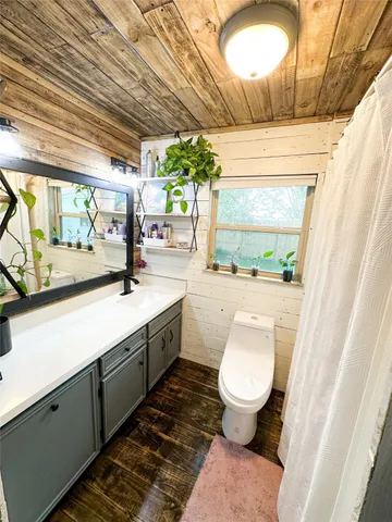a bathroom with a toilet sink and mirror