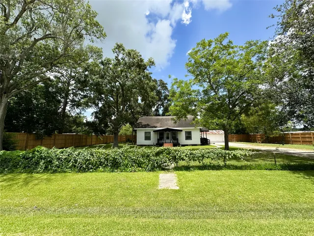 a house view with swimming pool and garden space
