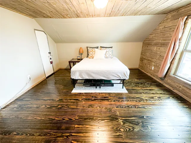 a bed sitting in a room next to a window