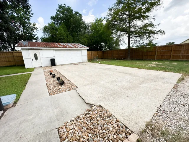a view of backyard of house and trees