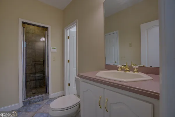 a bathroom with a bathtub sink vanity and mirror