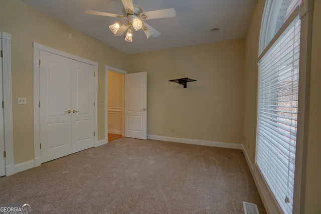 a view of a hallway with a door and wooden floor