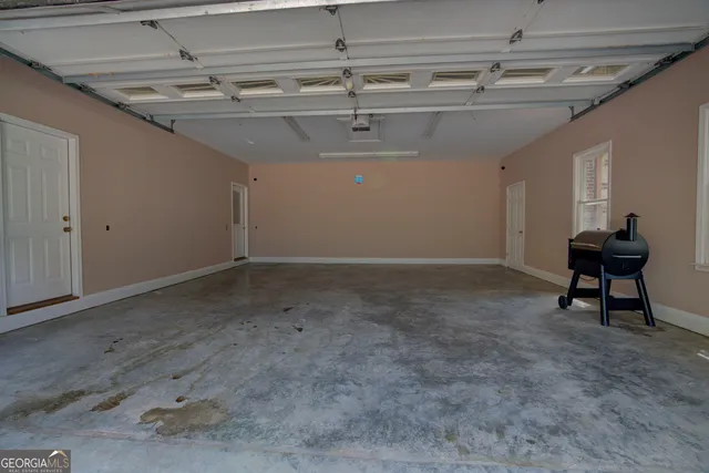 a view of a rooftop deck with table and chairs under an umbrella with wooden floor