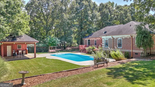a view of a house with a yard patio and fire pit