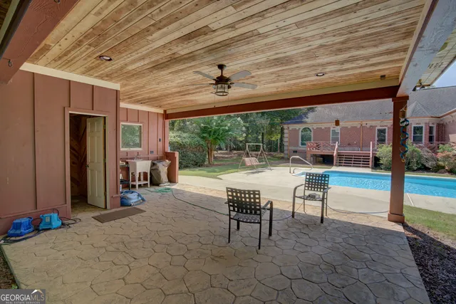 a car parked in front of a house with large trees