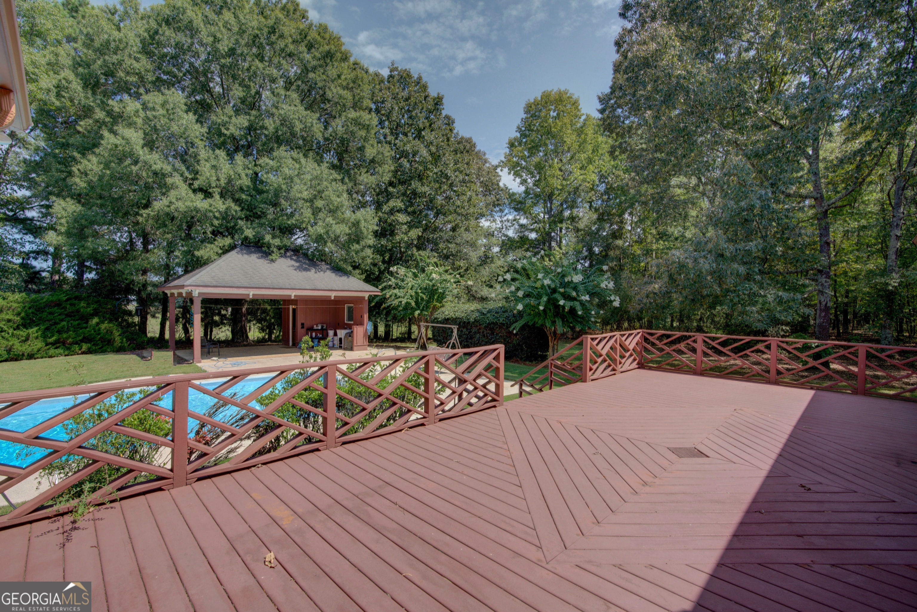 2011 Bailey Road Aragon, GA 30104 - Photo 36 of 66 a view of a rooftop deck with table and chairs under an umbrella with wooden floor