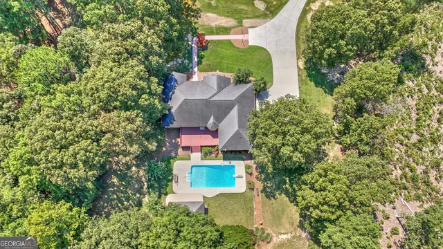 an aerial view of a house with a yard and garden