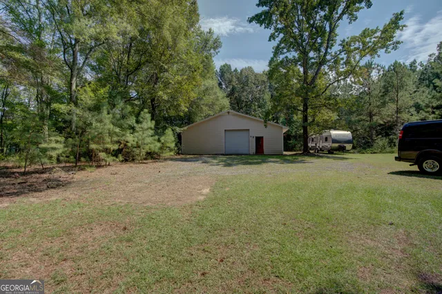 a view of hallway with a large window and wooden floor