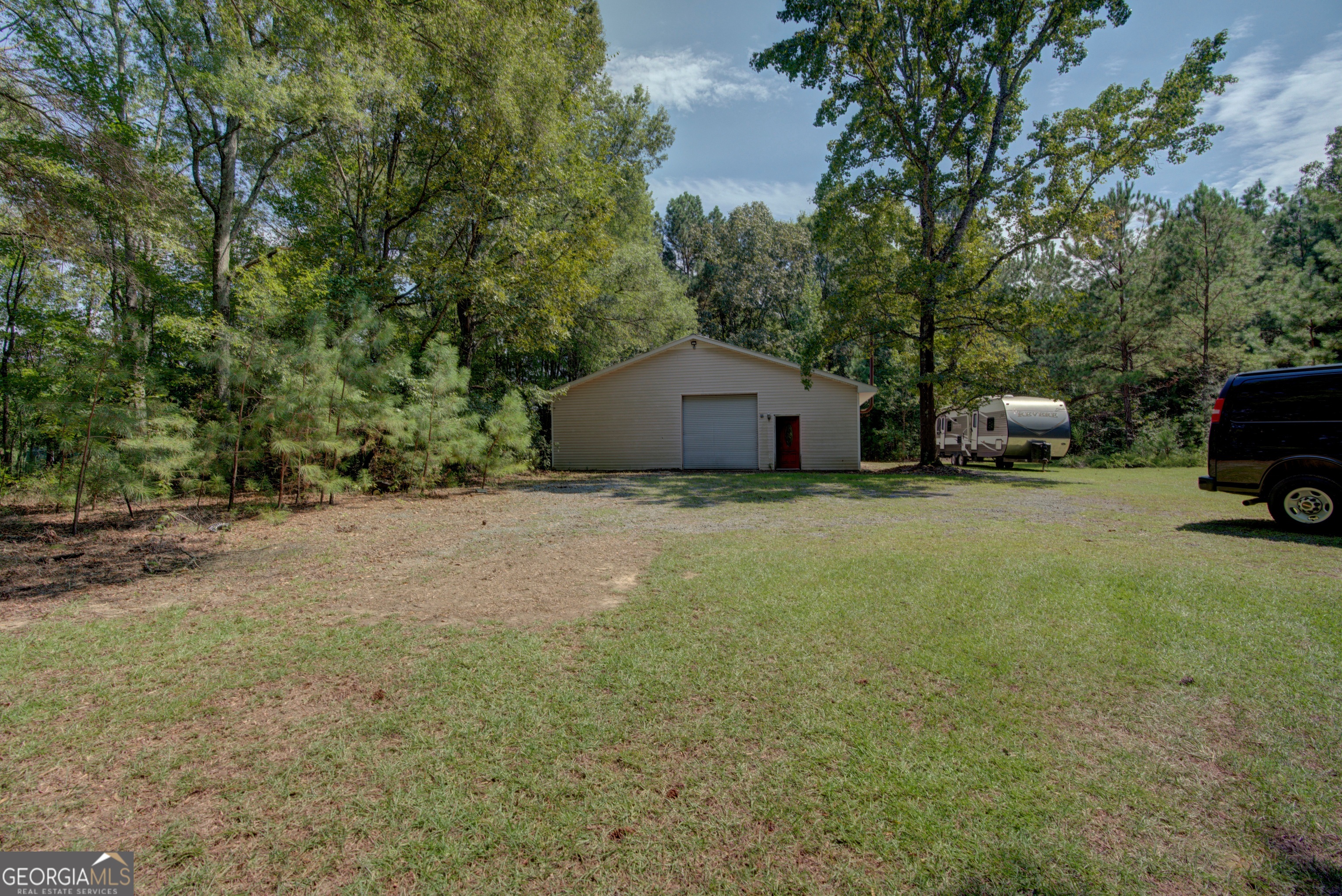 2011 Bailey Road Aragon, GA 30104 - Photo 42 of 66 a car parked in front of a house with large trees
