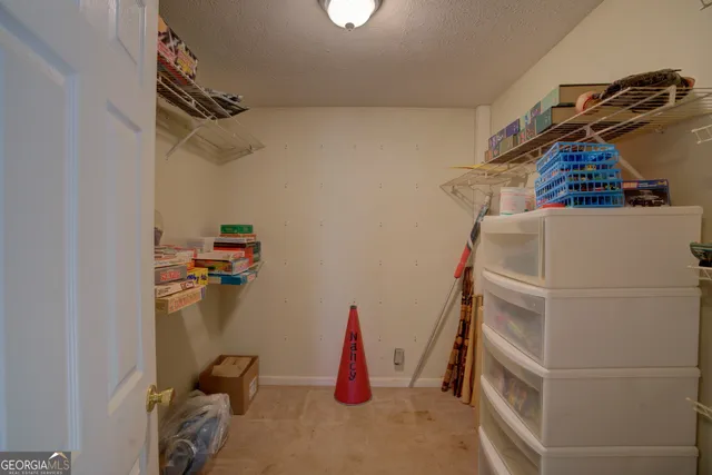 a view of a livingroom with furniture wooden floor and a ceiling fan
