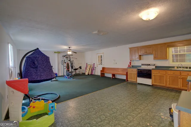 a view of a room with wooden floor and lounge chair