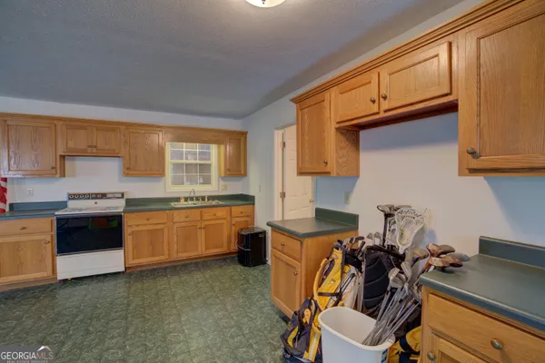 a open kitchen with stainless steel appliances granite countertop a sink and a stove
