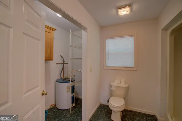 a large kitchen with stainless steel appliances lots of white cabinets