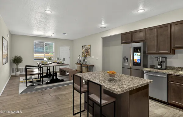 a kitchen with stainless steel appliances granite countertop a sink stove and cabinets