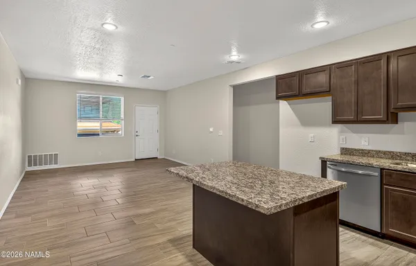 a view of a brick house with large windows