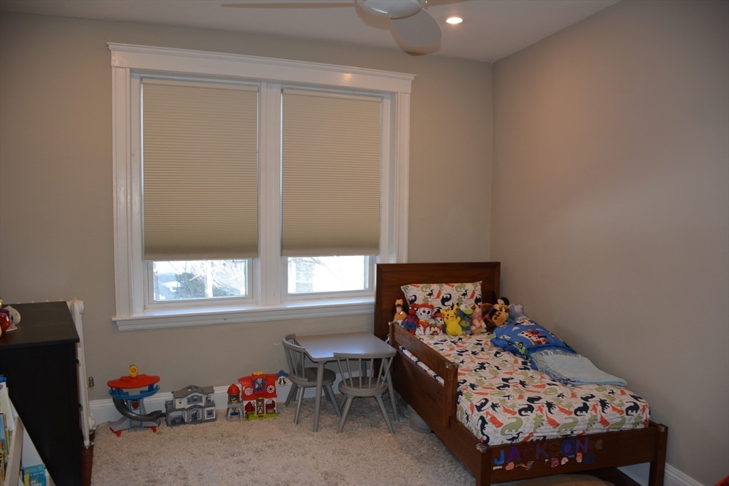 54 Dwight Street, Unit 3 Brookline, MA 02446 - Photo 11 of 16 a bed room with furniture and a window