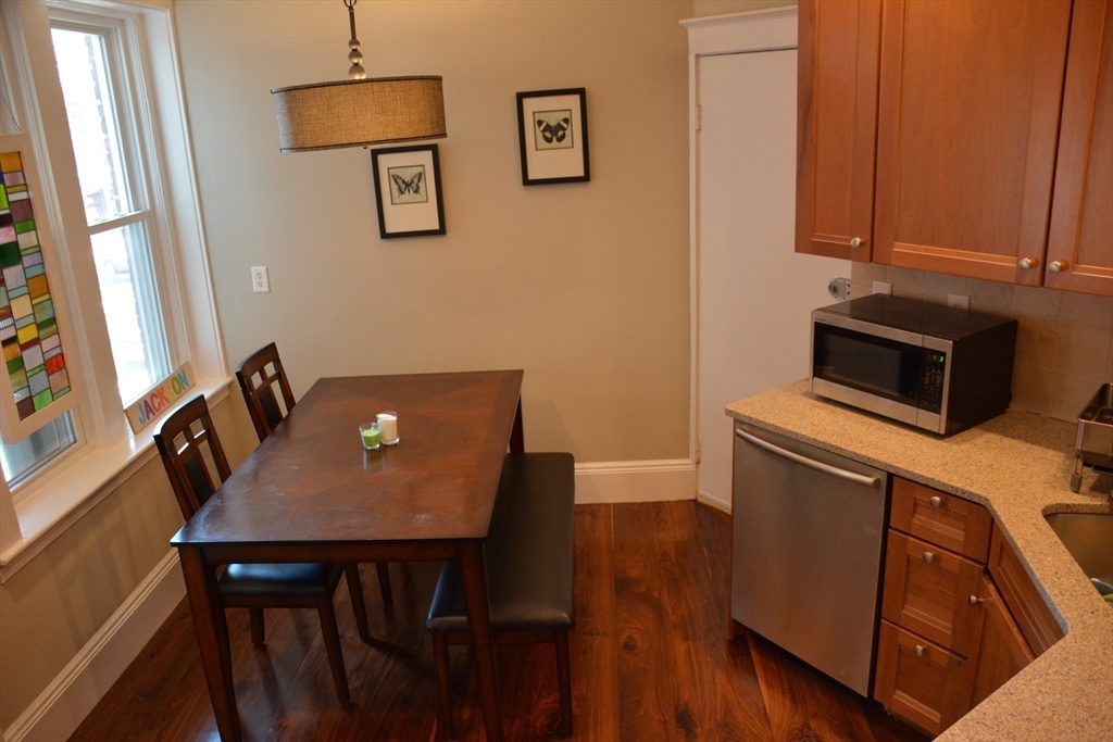 54 Dwight Street, Unit 3 Brookline, MA 02446 - Photo 13 of 16 a view of a workspace with furniture and wooden floor