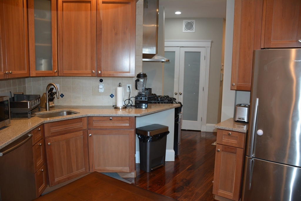 54 Dwight Street, Unit 3 Brookline, MA 02446 - Photo 14 of 16 a kitchen with a refrigerator sink and cabinets