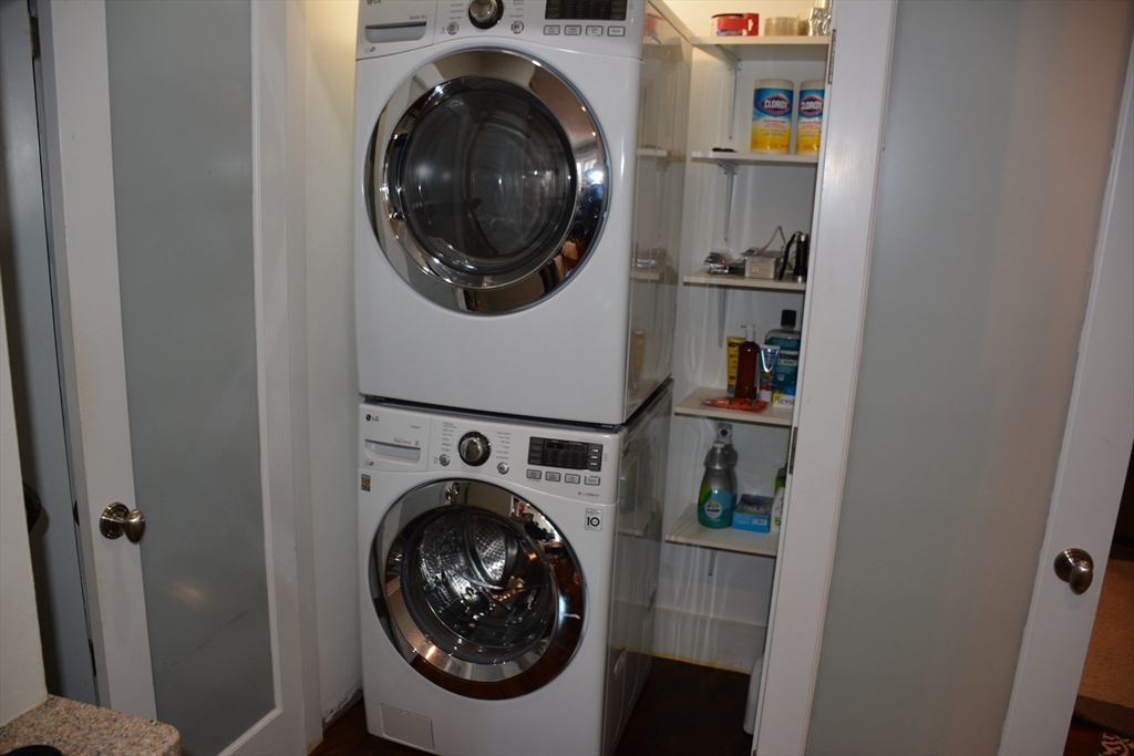 54 Dwight Street, Unit 3 Brookline, MA 02446 - Photo 15 of 16 a view of a hallway with washer and dryer