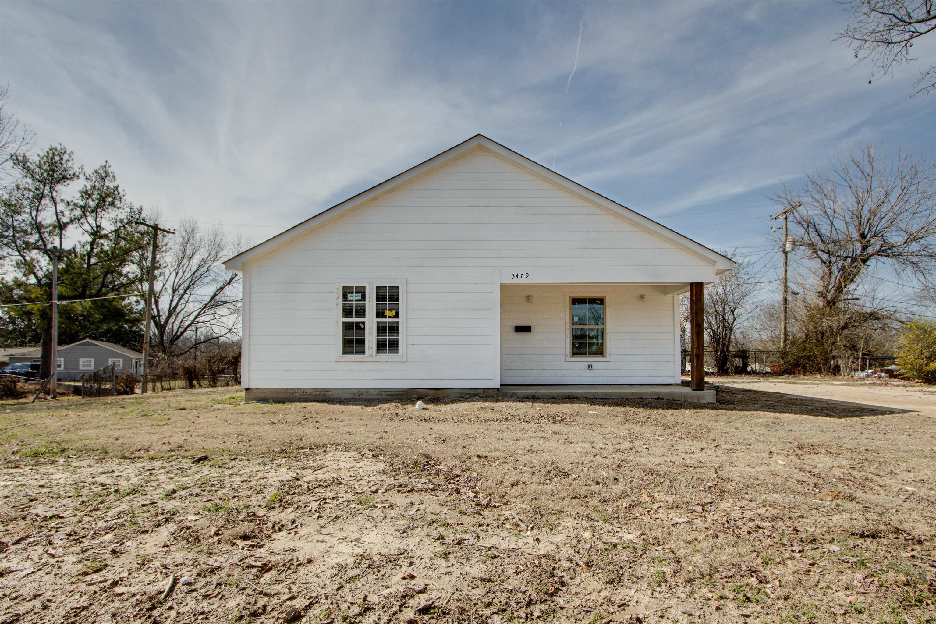a view of house with yard and trees in the background