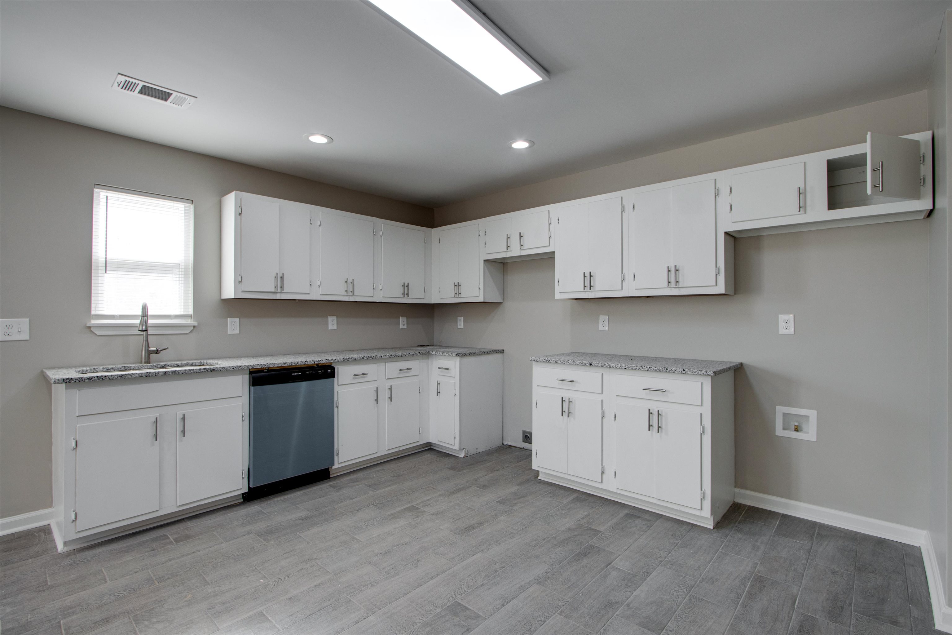 3479 Rochester Road Memphis, TN 38109 - Photo 3 of 12 a kitchen with granite countertop white cabinets and white appliances