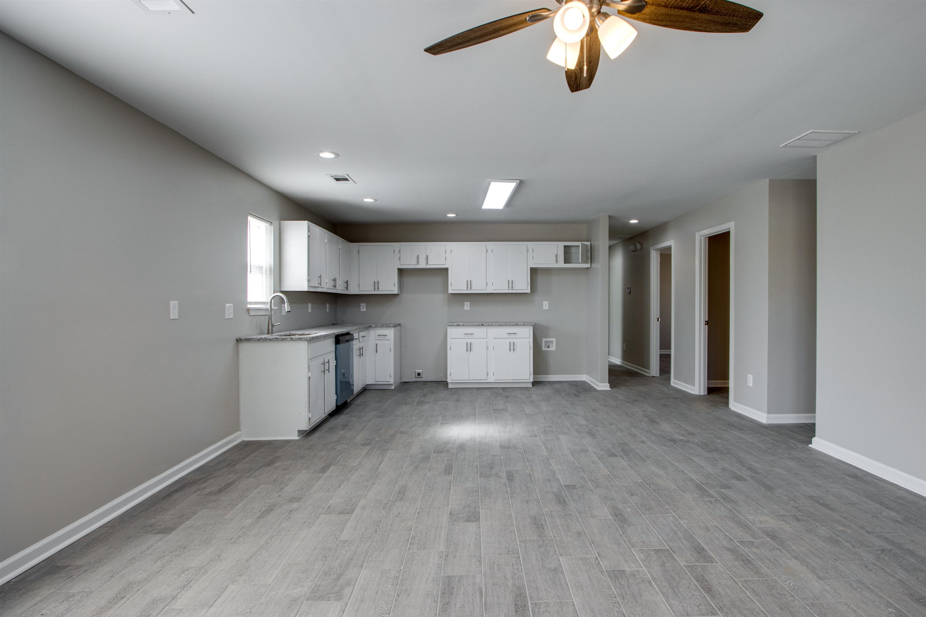 3479 Rochester Road Memphis, TN 38109 - Photo 4 of 12 a view of a kitchen with a sink cabinets and a window