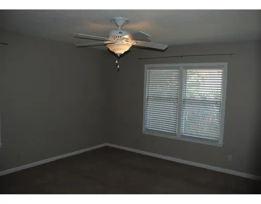 a view of wooden floor and a chandelier in a room
