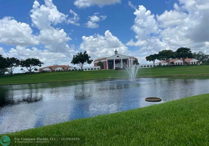 182 Ventnor L, Unit 182 Deerfield Beach, FL 33442 - Photo 18 of 28 an aerial view of a house with a yard and a fountain