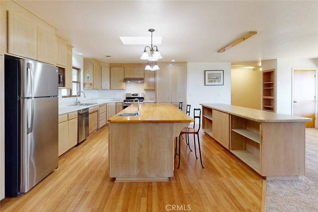 1718 Robinson Mill Road Bangor, CA 95914 - Photo 11 of 74 a kitchen with stainless steel appliances a dining table chairs stove and refrigerator