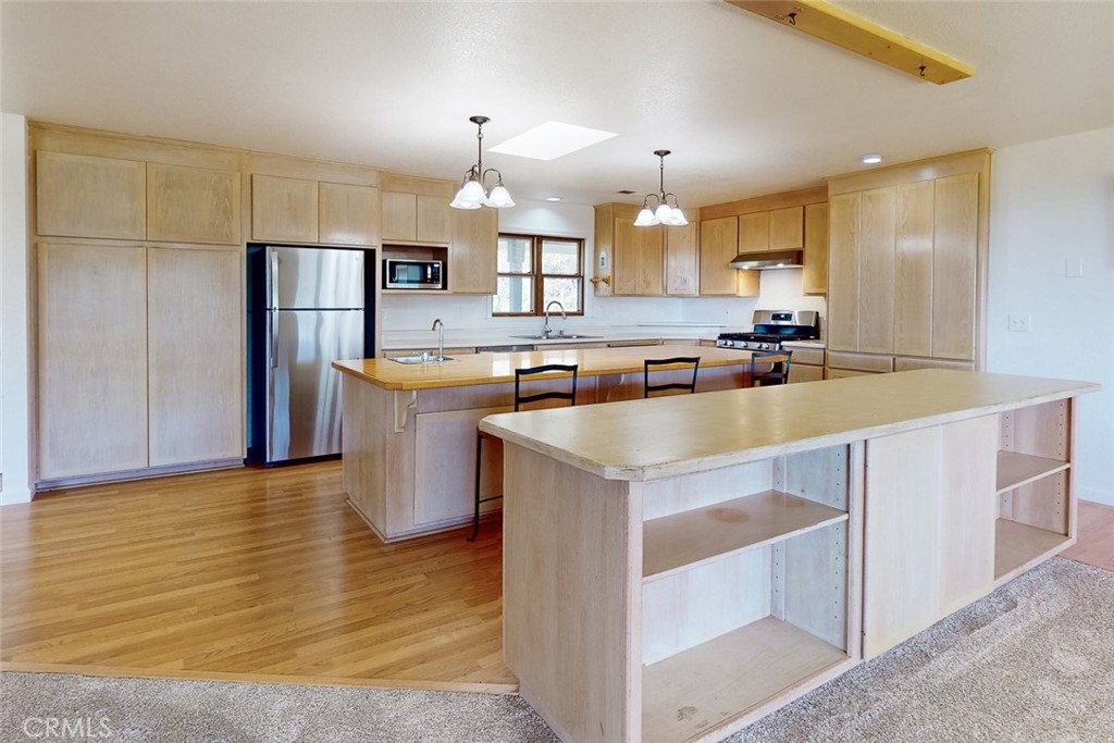 1718 Robinson Mill Road Bangor, CA 95914 - Photo 13 of 74 a kitchen with stainless steel appliances granite countertop a sink stove and refrigerator