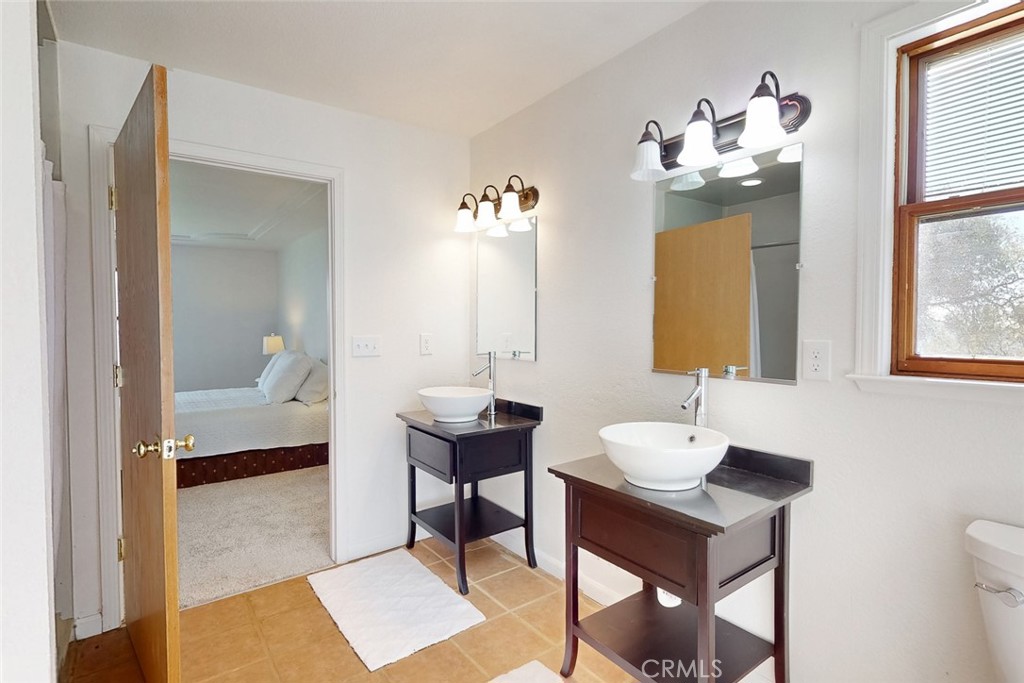 1718 Robinson Mill Road Bangor, CA 95914 - Photo 25 of 74 a en suite bathroom with a toilet sink and mirror