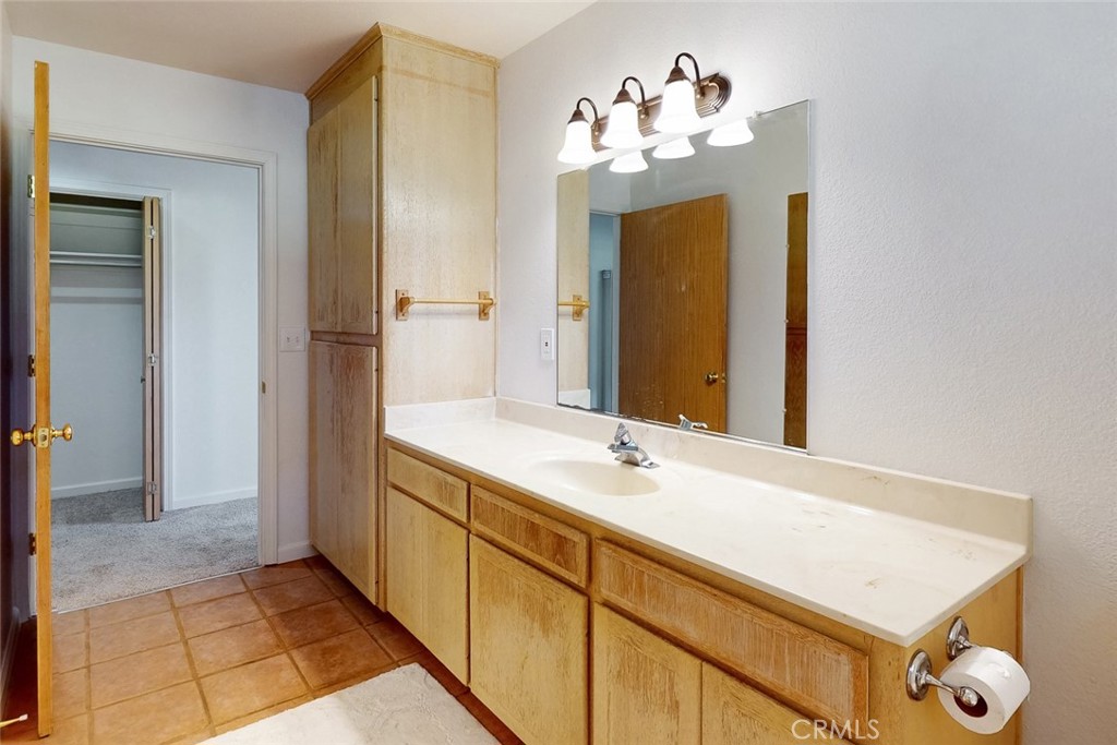1718 Robinson Mill Road Bangor, CA 95914 - Photo 29 of 74 a bathroom with a sink vanity and a mirror