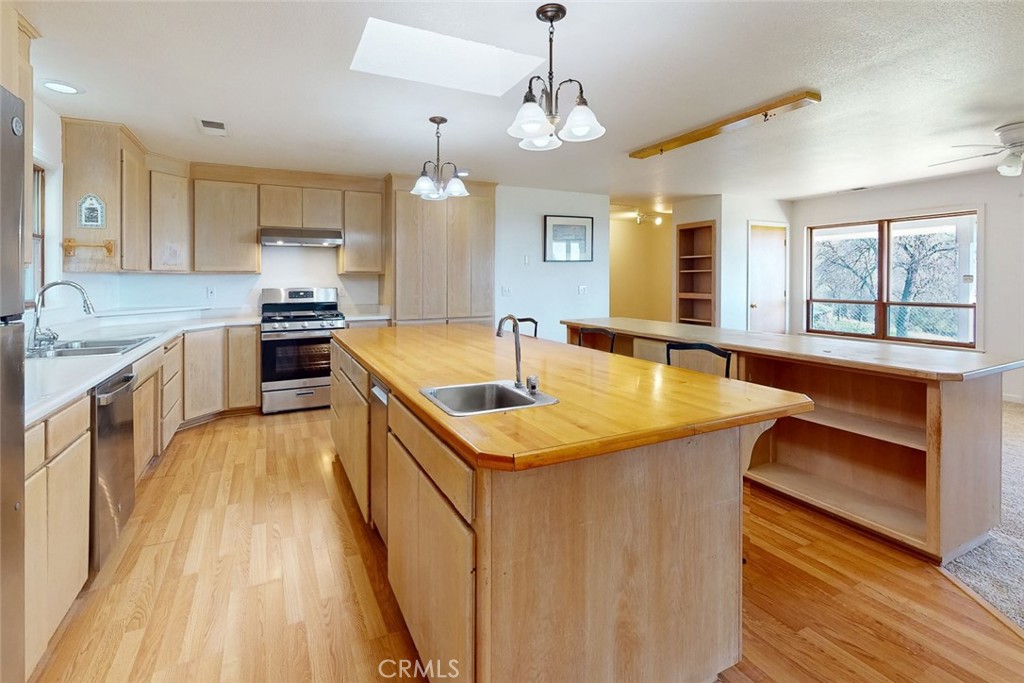 1718 Robinson Mill Road Bangor, CA 95914 - Photo 8 of 74 a kitchen with stainless steel appliances granite countertop a sink stove and wooden floor