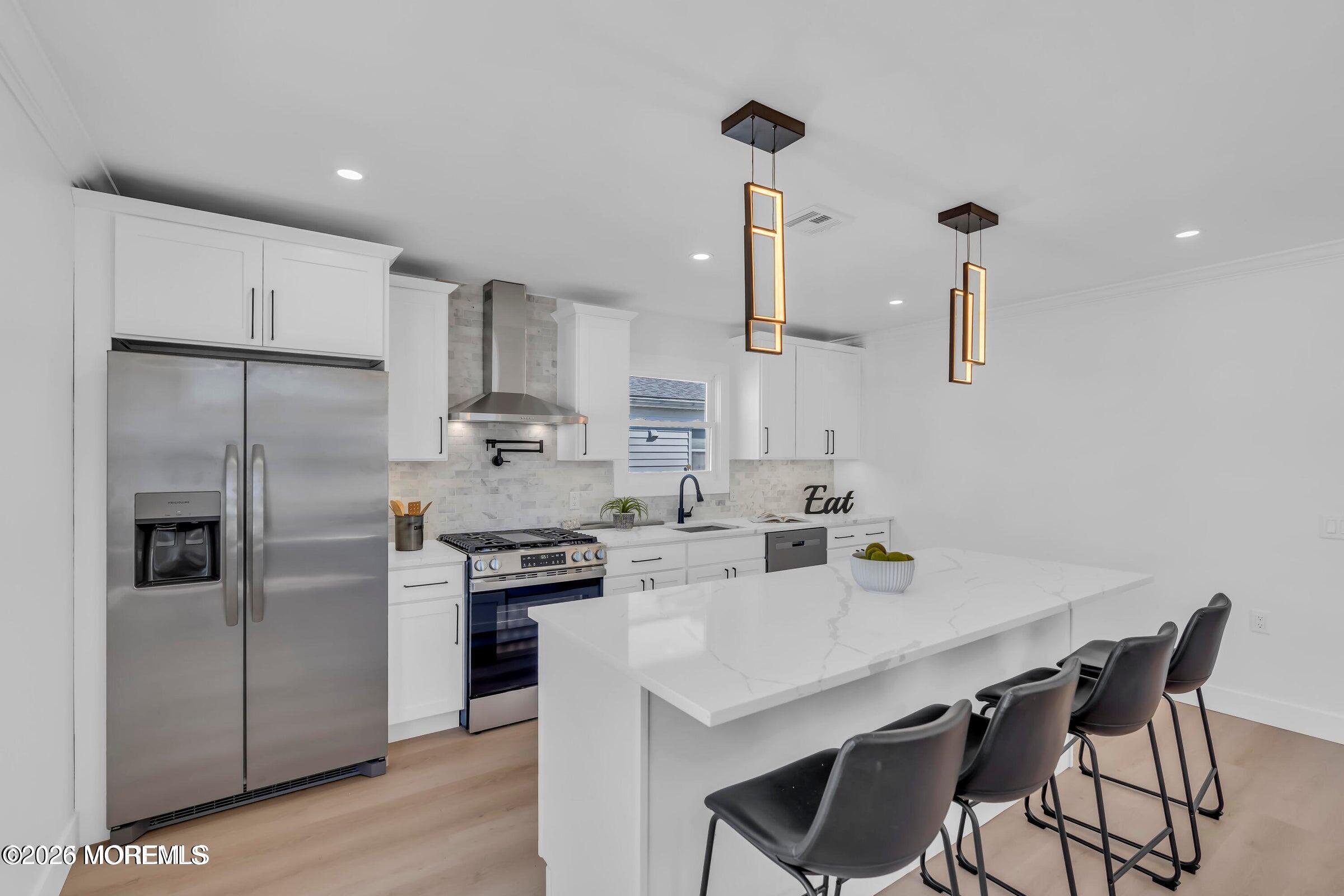 143 Davenport Road Toms River, NJ 08757 - Photo 19 of 41 a kitchen with stainless steel appliances a sink a stove a refrigerator and island