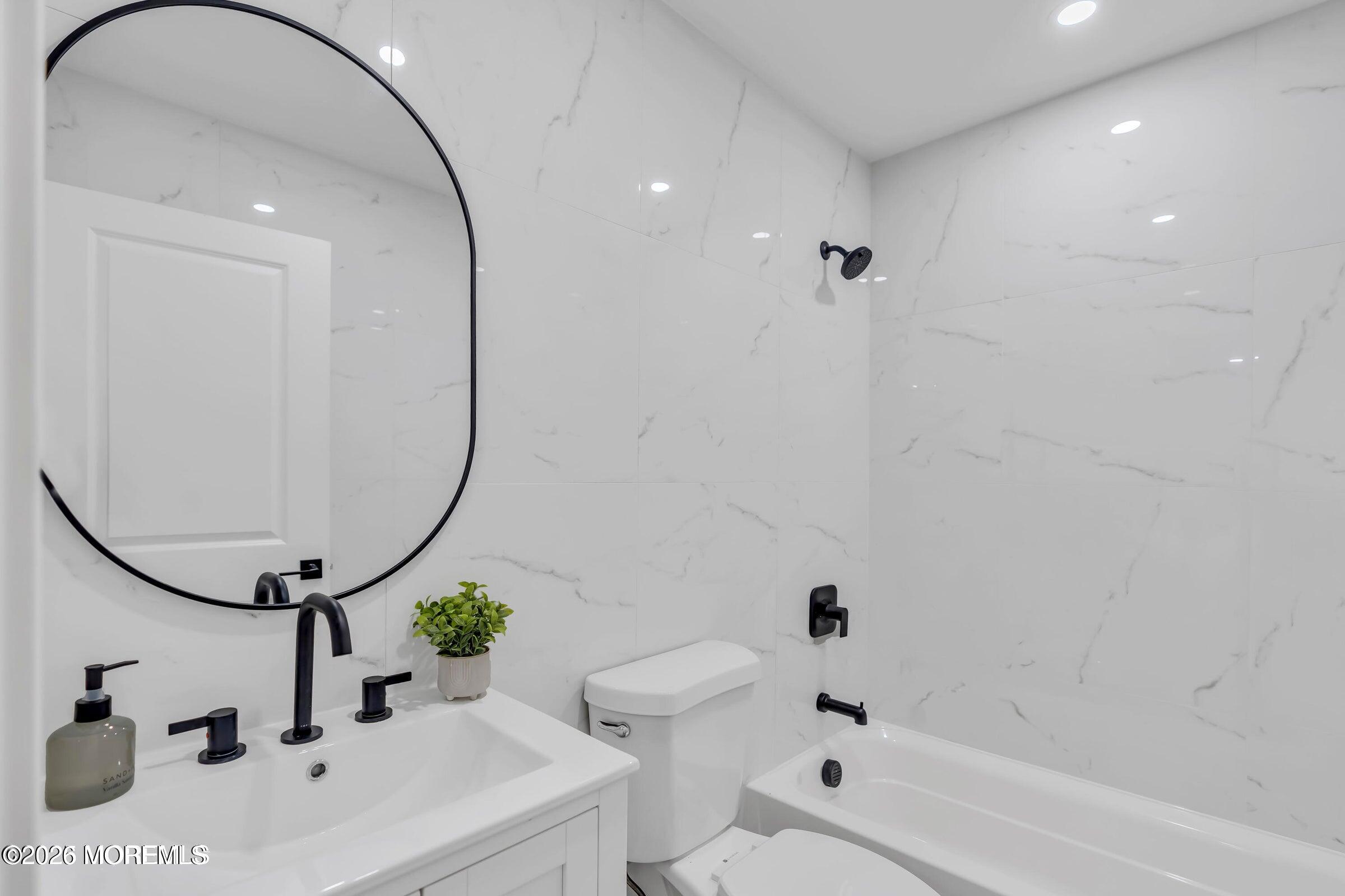 143 Davenport Road Toms River, NJ 08757 - Photo 26 of 41 a bathroom with a sink a toilet and shower