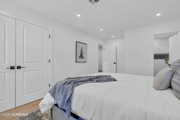 a bedroom with a bed and a painting