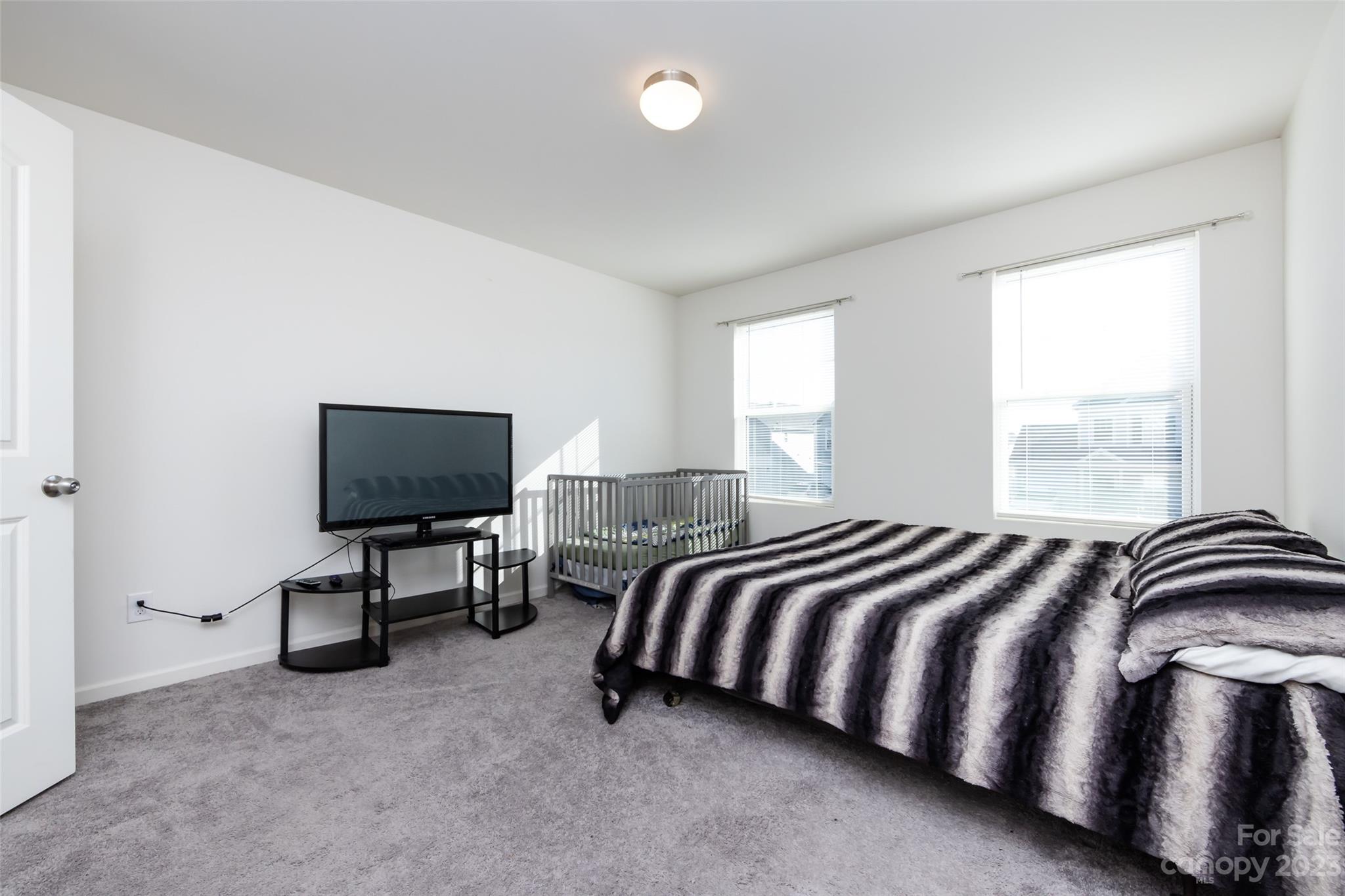 3823 Tersk Drive Midland, NC 28107 - Photo 15 of 24 a bedroom with a bed chair and a flat tv screen