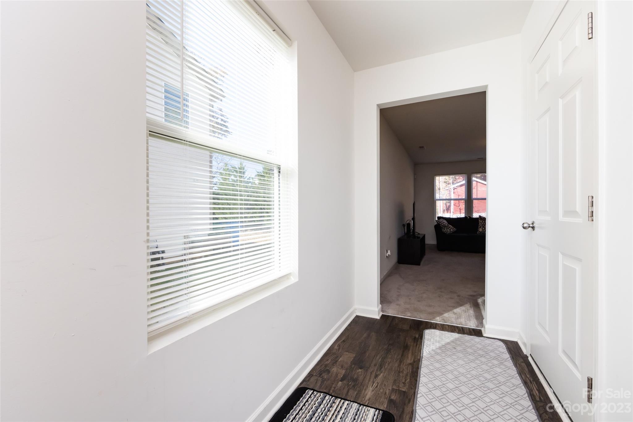 3823 Tersk Drive Midland, NC 28107 - Photo 2 of 24 a view of a hallway with wooden floor and a window
