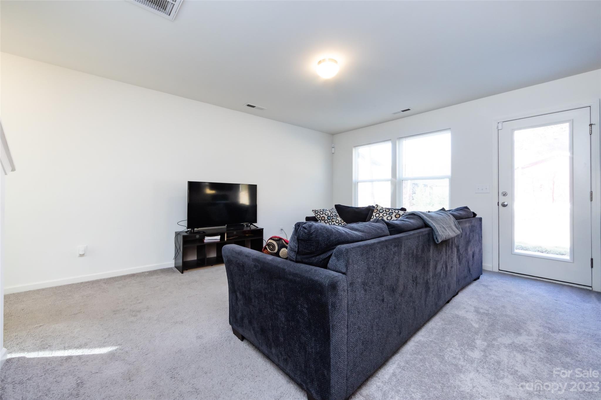 3823 Tersk Drive Midland, NC 28107 - Photo 6 of 24 a living room with furniture and a flat screen tv