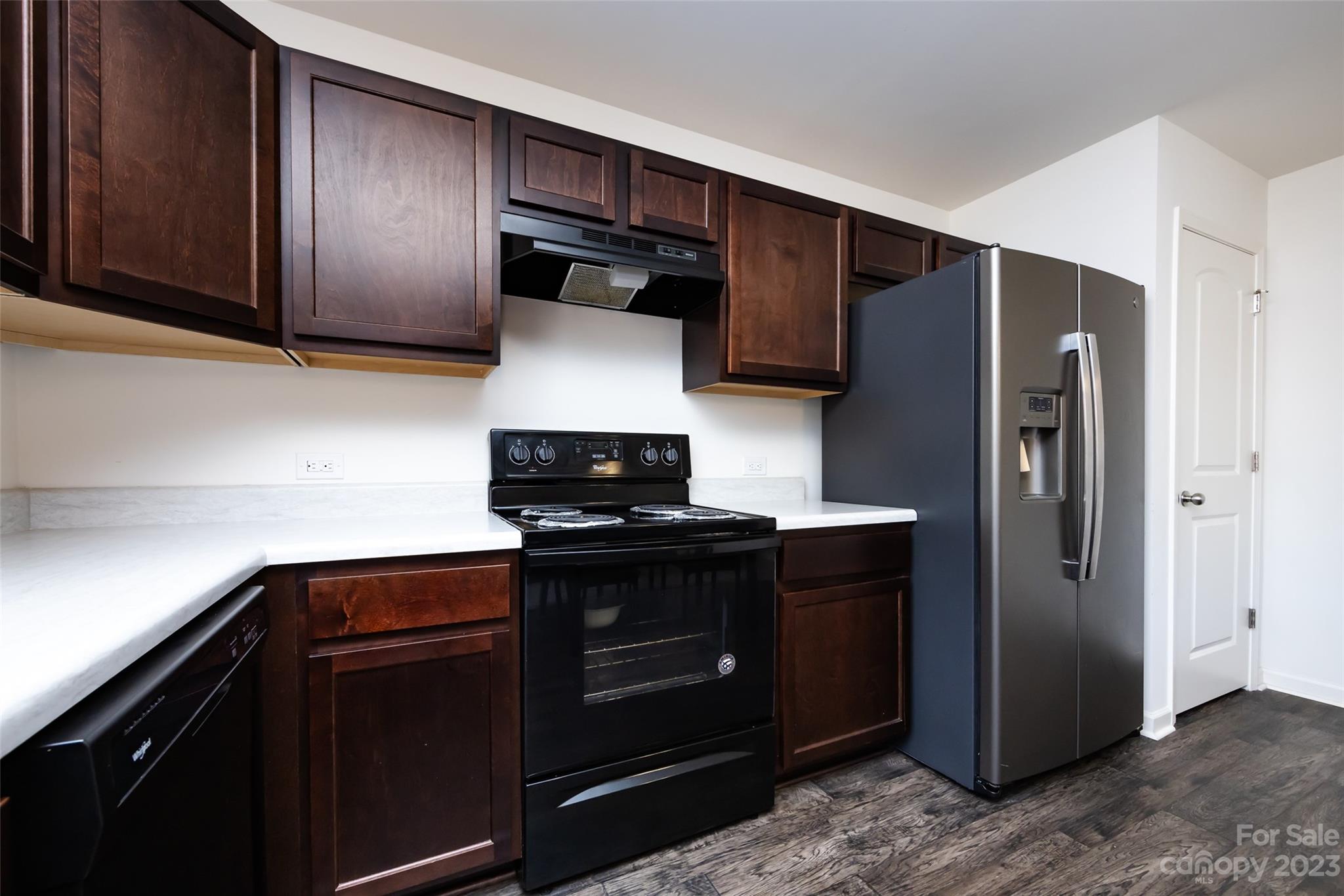 3823 Tersk Drive Midland, NC 28107 - Photo 9 of 24 a kitchen with stainless steel appliances granite countertop wooden cabinets and a stove top oven