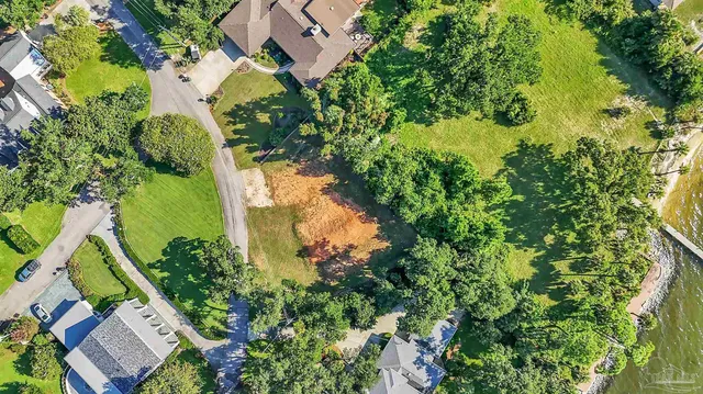 an aerial view of a residential houses with yard