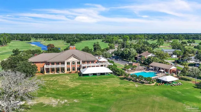 an aerial view of a house with garden space and street view