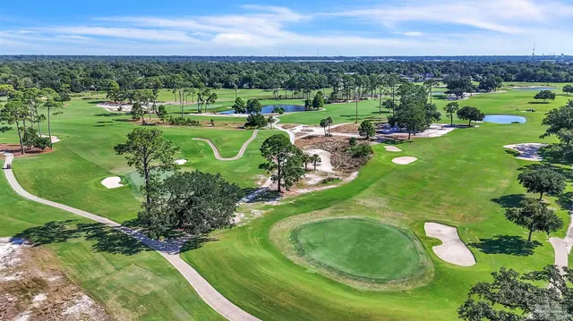 an aerial view of a golf course with parking space