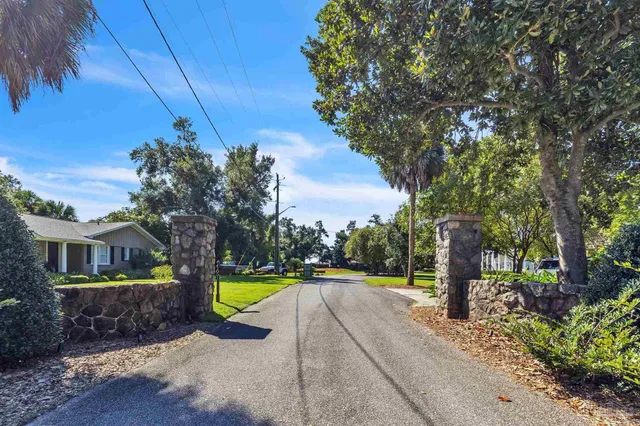 a view of a park with iron fence