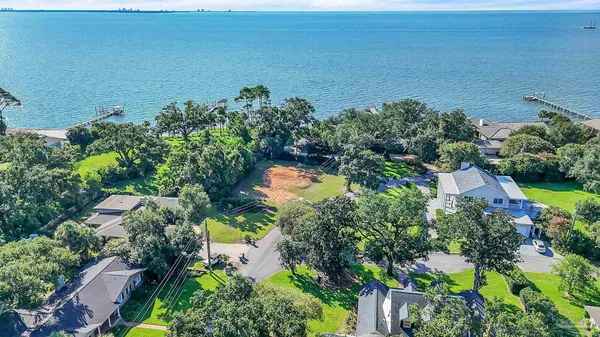 an aerial view of a houses with a yard