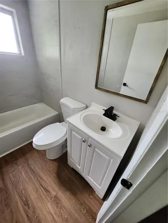 a bathroom with a sink a toilet and bathtub