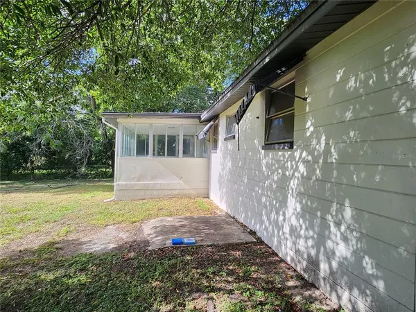 a view of house with backyard and garden