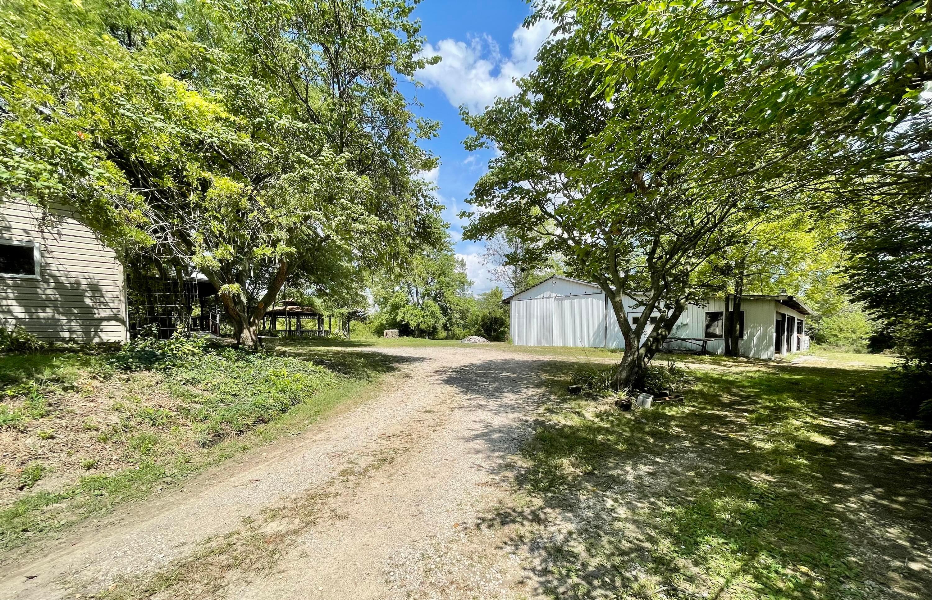 10671 Co Road East Liberty, OH 43319 - Photo 13 of 37 Lane going back behind house to the garage and barn